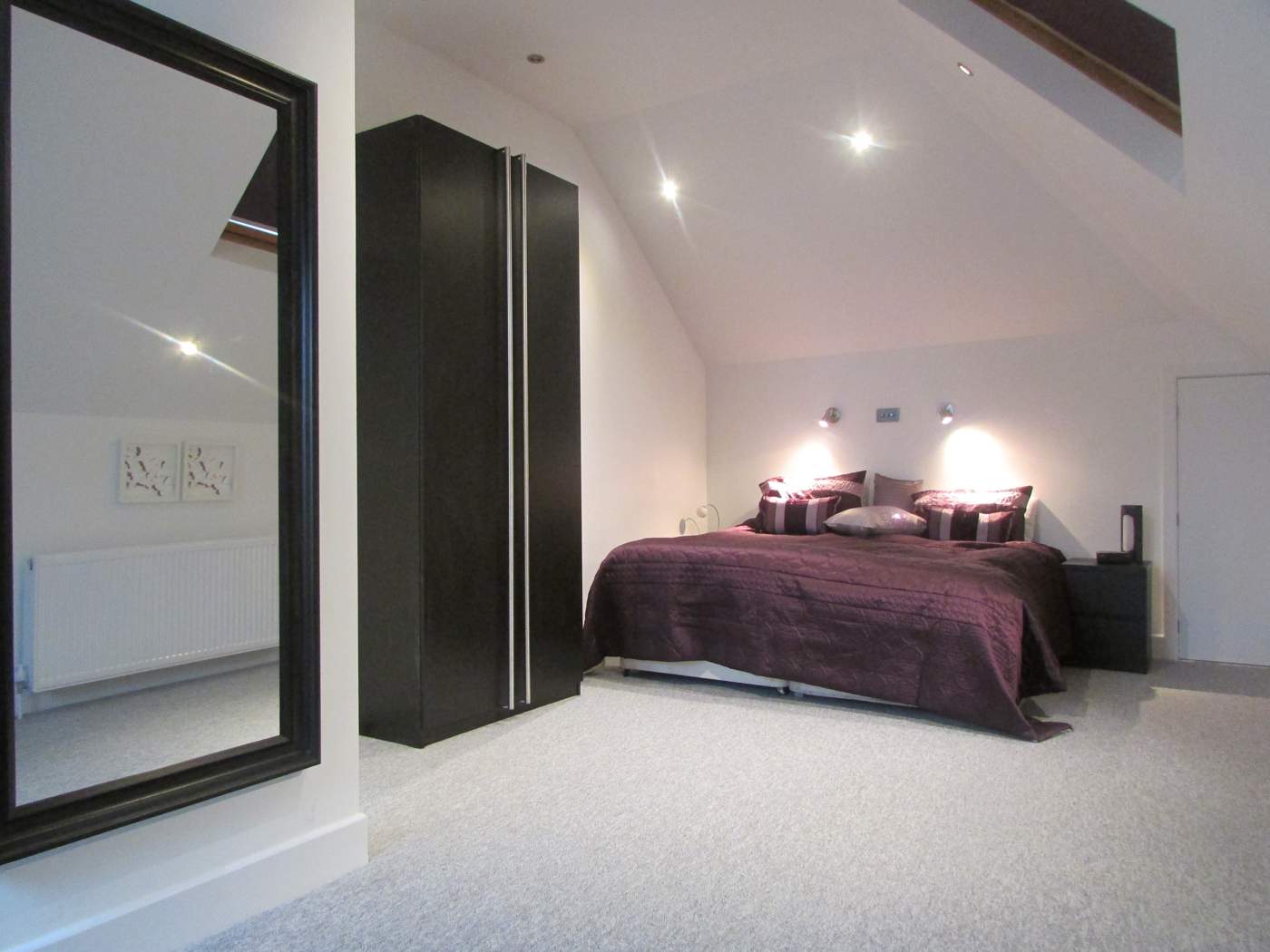 loft Bedroom with large mirror and wardrobe